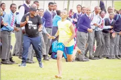  ?? (Pics: Mengameli Mabuza) ?? Ka-Schiele High School sprinter Susan Dlamini racing to the finish line as her teacher, Victor ‘Mavikane’ Dlamini (in cap) and fellow pupils, cheer her on.