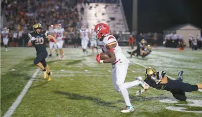  ?? S.T. CARDINAL/CORRESPOND­ENT ?? Edgewater running back C.J. Baxter Jr. gains 10 yards against Bishop Moore in Friday night’s season opener for both teams. Baxter rushed for more than 200 yards in the Eagles’ win.