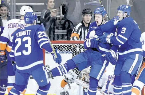  ?? THE CANADIAN PRESS FILES ?? Toronto’s Kasperi Kapanen, centre, celebrates a goal against the New York Islanders late last month. Kapanen has made his presence felt in every game since being called up from the Marlies seven games ago.