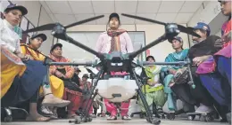  ?? ?? PUT TO THE TEST. Women aspiring to be remote pilots attending a class at Drone Destinatio­n training centre in Manesar, where they learn to fly drones.