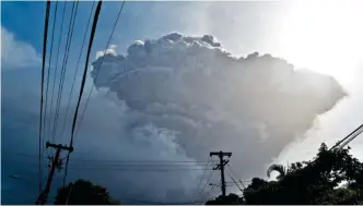  ?? AP PHOTO/ORVIL SAMUEL ?? Ash rises into the air as La Soufriere volcano erupts on the eastern Caribbean island of St. Vincent, seen from Chateaubel­air on Friday.