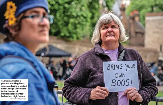  ?? Carl Court/Getty Images ?? A woman holds a placard mocking Boris Johnson during a protest near College Green next to the Houses of Parliament yesterday before last night’s vote