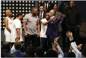  ?? AP/JEFF CHIU ?? The Rev. Al Sharpton hugs Stevante Clark during Thursday’s funeral services for police shooting victim Stephon Clark at Bayside of South Sacramento church in Sacramento, Calif.