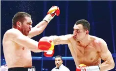  ??  ?? Ukrainian heavyweigh­t boxing world champion Wladimir Klitschko (R) fights Bulgarian challenger Kubrat Pulev in the IBF, IBO, WBO and WBA title bout at the O2 arena on November 15, 2014 in the northern German city of Hamburg. Klitsckko defeated Pulev. -...
