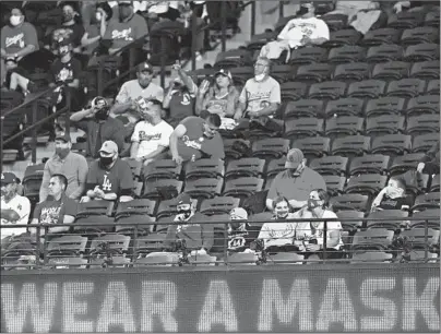  ?? In RONALD MARTINEZ/GETTY Arlington, Texas. ?? Spectators, most wearing face coverings, take in Game 5 of theWorld Series last month at Globe Life Field