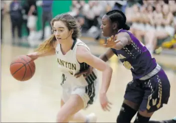  ?? Nikolas Samuels/The Signal ?? Canyon’s Talia Taufaasau (3) drives in toward the basket as Valencia’s Tiana Beale (14) guards her at Canyon on Friday. Canyon won the game 45-37.