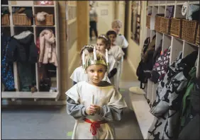  ?? MATHIAS SVOLD / NEW YORK TIMES FILE ?? Children take part in a procession to commemorat­e Saint Lucy’s Day on Nov. 29, 2019, at a public child care center in Copenhagen, Denmark. Rich countries contribute an average of $14,000 per year for a toddler’s care, compared with $500 in the U.S.