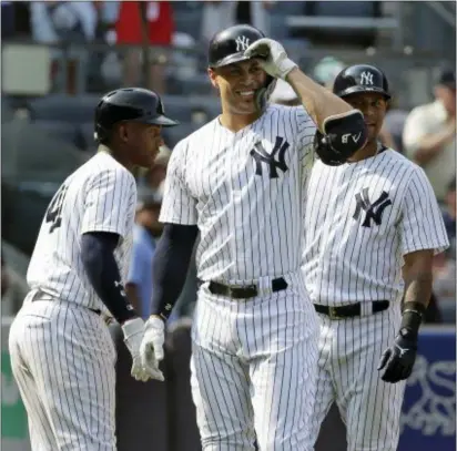  ?? THE ASSOCIATED PRESS ?? Yankees’ Giancarlo Stanton, center, reacts after believing he hit a home run during the eighth inning of Thursday’s game against the Tampa Bay Rays at Yankee Stadium. Upon review, the umpires decided it was a ground rule double.