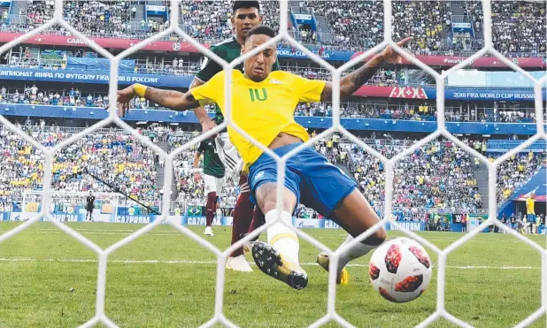  ?? Picture: AFP PHOTO ?? SUPERB SHOT: Neymar scores Brazil’s opening goal in the side’s 2-0 win in their World Cup round of 16 football match against Mexico.