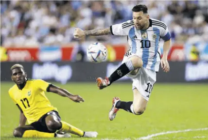  ?? (Photo: Observer file) ?? Argentina’s Lionel Messi (right) gets away from Jamaica’s Damion Lowe during the internatio­nal friendly football match at Red Bull Arena in Harrison, New Jersey, on Tuesday, September 27, 2022.