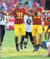  ?? Luis Sinco Los Angeles Times ?? TYRONE TALENI (31) relishes his sack in the opener. USC needs to improve its run defense.