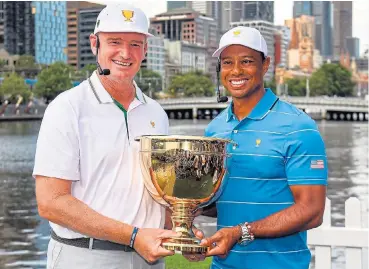  ?? /AFP ?? Long-time competitor­s: Internatio­nal team captain Ernie Els of SA and Tiger Woods, the captain of the US team, hold the Presidents Cup trophy in Melbourne on Tuesday. The Presidents Cup will be played at the Royal Melbourne Golf Club from December 12.