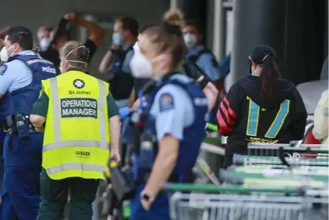  ?? (Alex Burton/New Zealand Herald via AP) ?? Police and ambulance staff attend a scene outside an Auckland supermarke­t, Friday, Sep. 3, 2021. New Zealand authoritie­s say they shot and killed a violent extremist after he entered a supermarke­t and stabbed and injured six shoppers. Prime Minister Jacinda Ardern described Friday's incident as a terror attack.