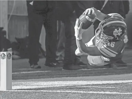  ?? TY WRIGHT/THE ADVOCATE ?? Newark Catholic junior Mason Hackett dives across the goal line inside the pylon during the Division VII state final against Marion Local. It would mark Newark Catholic's lone touchdown in a 42-7 loss.