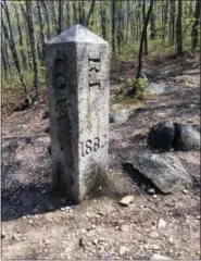  ?? PAT EATON-ROBB — THE ASSOCIATED PRESS ?? This photo shows the granite monument that marks the spot where Connecticu­t, Massachuse­tts and Rhode Island meet in Thompson, Conn. There’s an unusual travel hobby that has people visiting the woods of Thompson, and other remote spots across the...