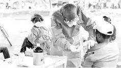  ??  ?? A Congolese health worker administer­s Ebola vaccine to a woman who had contact with an Ebola sufferer in the village of Mangina in North Kivu province of the Democratic Republic of Congo. — Reuters photo