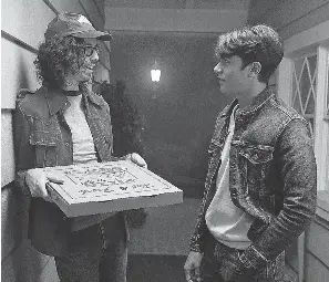  ??  ?? Bill Kottkamp as Pizza Guy and Michael Cimino as Bob Palmeri in “Annabelle Comes Home.” JUSTIN LUBIN/WARNER BROS.