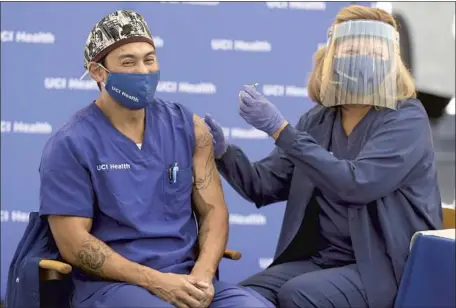  ?? Gary Coronado Los Angeles Times ?? ERIK MARA, a respirator­y therapist at UCI Health, gets the COVID- 19 vaccine from Pam Samuelson, a registered nurse. From July 1, 2019 to July 1, 2020, California saw a net population gain of only 21,200 new residents. As of July, the state’s population was 39.78 million.