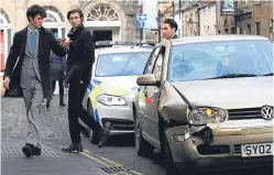  ?? Picture: Mhairi Edwards. ?? The public look on after the VW Golf hit a shop front in St Andrews, injuring Chinese exchange students.