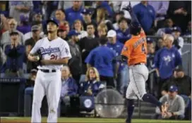  ?? MARK J. TERRILL — THE ASSOCIATED PRESS ?? Houston’s George Springer, right, celebrates after his two-run home run off Dodgers starting pitcher Yu Darvish during the second inning Game 7Wednesday in Los Angeles. of