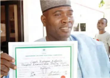  ??  ?? Jimoh Agboola Raheem displaying the Certificat­e of Return presented to him by INEC