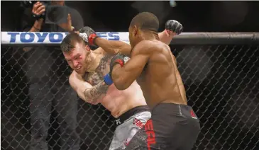  ?? CLAIRE OSBORNE / AMERICAN-STATESMAN ?? Austin native Geoff Neal (right) made an impression in his UFC debut, punishing Brian Camozzi before a first-round stoppage. He received a $20,000 purse and a $3,500 Reebok bonus for the win.