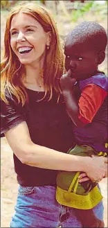  ??  ?? STORM: Stacey hugs child in Uganda