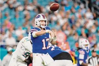  ?? ?? Buffalo Bills quarterbac­k Josh Allen throws a pass during the third quarter against the Miami Dolphins at Hard Rock Stadium last Sunday in Miami Gardens, Fla.