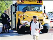  ??  ?? C.J. Moore, 6, exits a bus and heads towards Britton Elementary for his first day of first grade in Oklahoma City on Aug. 12. [BRYAN TERRY/OKLAHOMAN ARCHIVES]