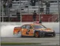  ?? JOHN AMIS — THE ASSOCIATED PRESS ?? Brad Keselowski passes the grandstand after winning a NASCAR Monster Cup series race at Atlanta Motor Speedway.