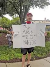  ??  ?? Robert Bean of Hamilton County protests the recent mask mandate on Sunday. Bean said he believes mandating facial coverings is an overreacti­on to COVID-19 cases and hospitaliz­ations.