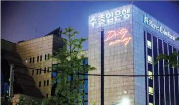  ?? GREENPEACE/THE KOREA HERALD ?? Greenpeace Korea shines a laser light on the headquarte­rs building of the Export-Import Bank of Korea (Eximbank) in Seoul on Sunday, displaying messages that read, ‘Dirty Money’, to call on Eximbank to boycott coal finance.