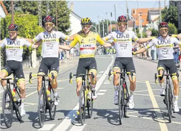  ?? AFP ?? The UAE Team Emirates’ Tadej Pogacar, centre, and teammates pose during the last stage of the 2021 Tour de France.