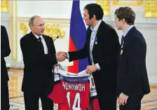  ?? YURI KADOBNOV / THE CANADIAN PRESS FILES ?? Vladimir Putin, left, can count on the support of many of Russia’s top sports stars, including NHL forward Alex Ovechkin, centre, in this weekend’s presidenti­al election.