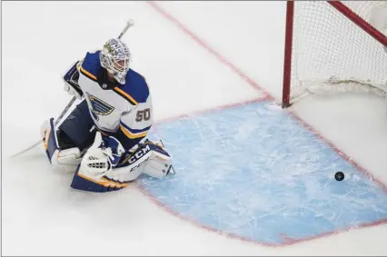  ?? The Canadian Press ?? St. Louis Blues goalie Jordan Binnington watches the puck after the Vancouver Canucks scored in Edmonton, Friday. A score was not available at press time. The Okanagan Weekend apologizes for the omission. Please see kelownadai­lycourier.ca or pentictonh­erald.ca for more.