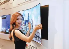  ?? Courtesy of LG Display ?? A model promotes LG Display’s 65-inch ultra high-definition wallpaper OLED television.