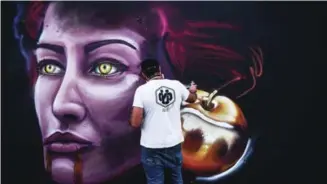  ??  ?? Italian graffiti artist Andrea Castegnino works on his piece during the internatio­nal graffiti art festival in Pristina on May 19, 2017. — AFP