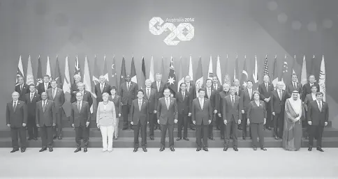  ??  ?? Photo shows participan­ts of the G20 Leaders’ Summit in Brisbane. G20 leaders, representi­ng the bulk of the world’s economy, committed to reform measures to lift their collective growth by an extra 2.1 per cent by 2018, despite evidence of a slowdown in...