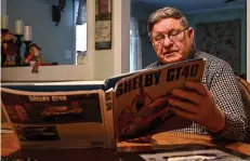  ?? Staff photo by Hunt Mercier ?? ■ Frank Lance talks about working for Ford and competing against Ferrari while flipping through a Shelby car book in his kitchen in Queen City, Texas.