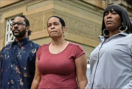  ?? Stephanie Strasburg/ Post- Gazette ?? Relatives of Pittsburgh police Officer Calvin Hall, from left, brother Curtis Hall, sister Eugenia Hall Miller and fiancee Angel Warren, talk to the media before Officer Hall’s viewing Monday at Soldiers & Sailors Memorial Hall & Museum in Oakland.