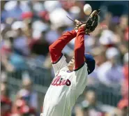  ?? LAURENCE KESTERSON — THE ASSOCIATED PRESS ?? Philadelph­ia Phillies third baseman Ronald Torreyes (74) catches a fly from Cincinnati Reds’ Joey Votto during the third inning of a baseball game, Sunday.