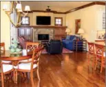  ??  ?? Left: In addition to a screened porch, there is a covered porch that overlooks the golf course. Right: The cozy hearth room is open to the kitchen and breakfast area for easy living.