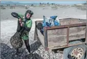  ?? MARTIN BERNETTI / AGENCE FRANCE-PRESSE ?? A fisherman puts saltwater clams known as ‘machas’ into a trailer at a beach in La Serena, about 400 kilometers north of Santiago, Chile.