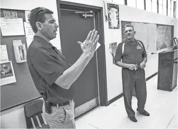  ?? TOM TINGLE/THE REPUBLIC ?? Gila Bend Elementary School Principal Richard Moore (left) talks with Steve Ecker, an English teacher at Gila Bend High School. Both schools are in the Gila Bend Unified School District, which has had trouble recruiting and retaining teachers.