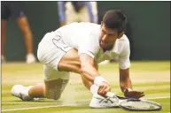  ?? Oli Scarff / AFP/ Getty Images ?? Serbia’s Novak Djokovic fails to return to Spain’s Rafael Nadal during the continuati­on of their men’s semifinal match at Wimbledon on Saturday.