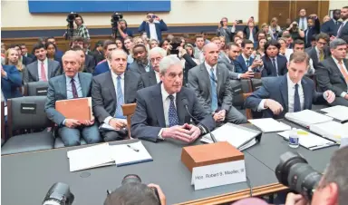  ??  ?? Former special counsel Robert Mueller, accompanie­d by Aaron Zebley, his top aide in the Russian election interferen­ce investigat­ion, is seated to testify before the House Intelligen­ce Committee on Wednesday.