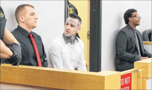  ?? GLEN WHIFFEN/THE TELEGRAM ?? From left, defendants Gary Hennessey, Mitchell Nippard and Abdifatah Mohamed sit in the prisoners’ dock Monday in St. John’s.