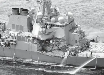  ?? AFP/Getty Images ?? THE DESTROYER FITZGERALD suffered damage to two berthing areas after colliding with a much larger container vessel off the coast of Japan before dawn Saturday. Sailors would have been asleep in their berths.