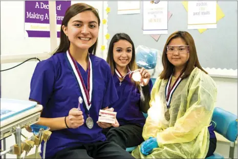  ?? VINCENT OSUNA PHOTO ?? FROM LEFT: Southwest High School students Ariana Romo, Mildred Bernal and Sowon Moon pose inside the dental assistant classroom at Southwest High on Thursday afternoon in El Centro. Romo, Bernal and Moon finished as the top three finalist in the Dental...