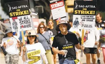  ?? CHRIS PIZZELLO CHRIS PIZZELLO/INVISION/AP ?? SAG-AFTRA members picket at Walt Disney Studios in Burbank on Wednesday. Their strike began in July.